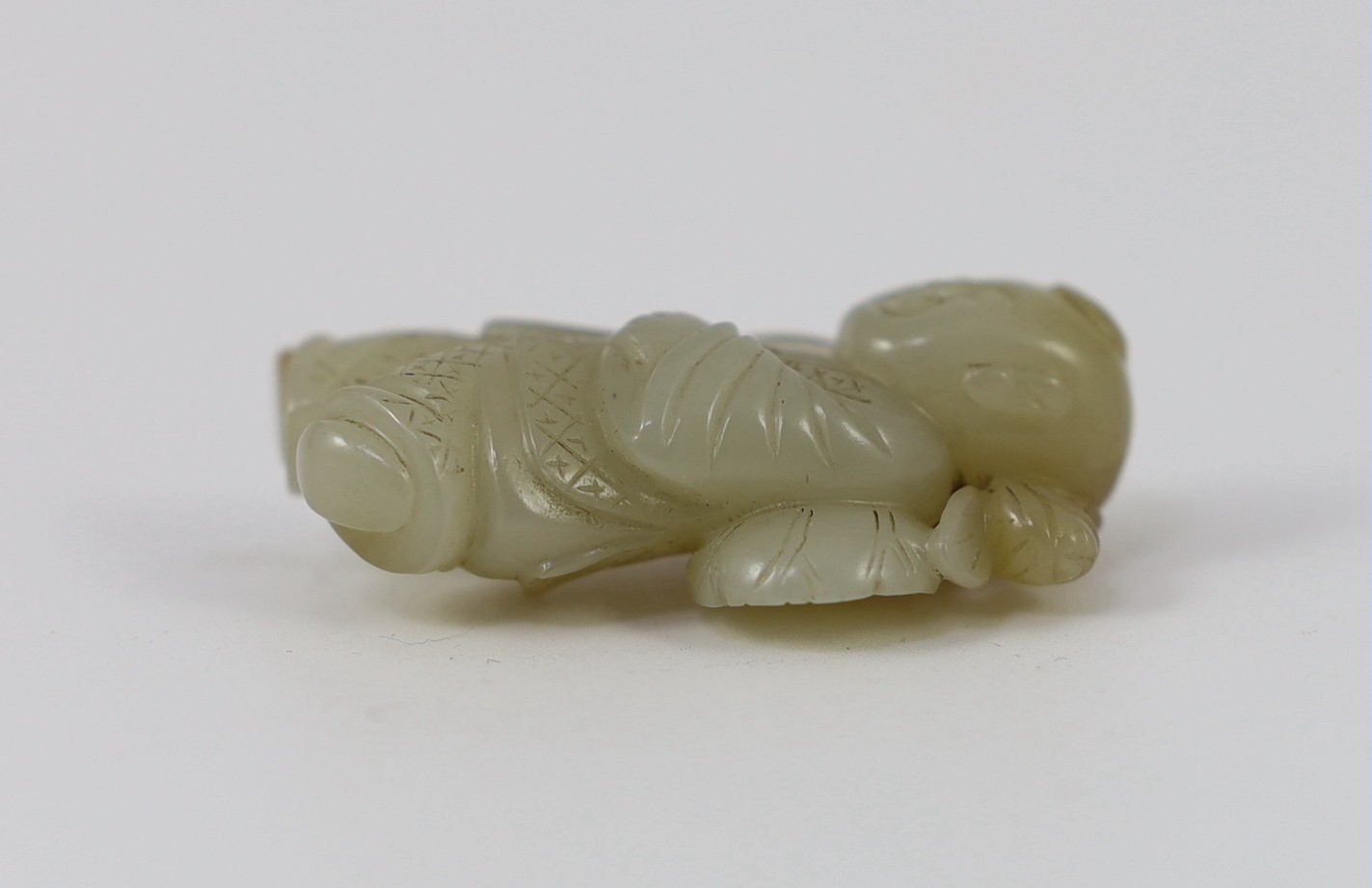 A Chinese pale celadon jade figure of a boy, 19th century, 4.1cm high